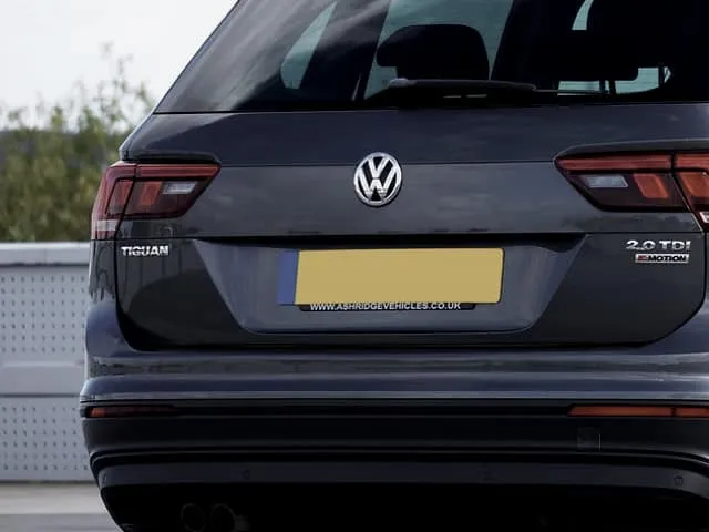 The rear of an SUV carrying a blank dealer plate.