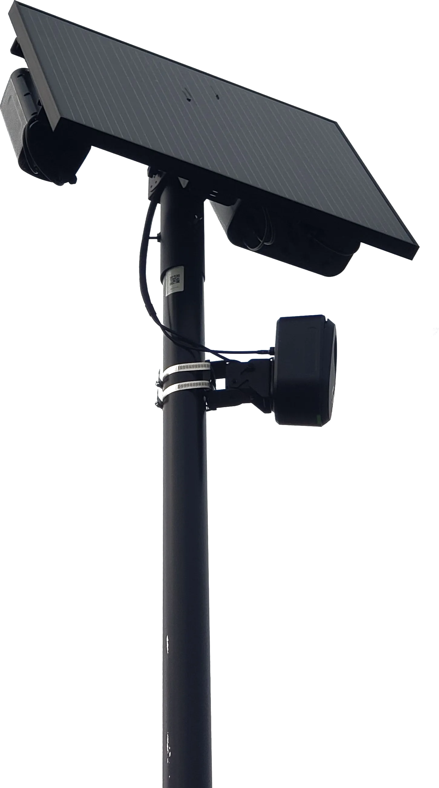 A Flock Safety automated licence plate reader: a camera head and solar panel mounted on a roadside pole.